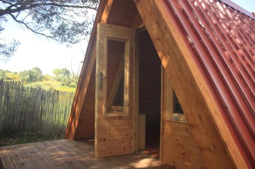 an open door of a wooden house with a roof at Nectar Rentals in Varákkes