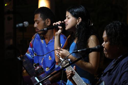 a man and a woman singing into a microphone at Aquarius On The Beach in Nadi