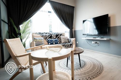 a living room with a couch and a table at Jesselton Quay by Pinstay in Kota Kinabalu
