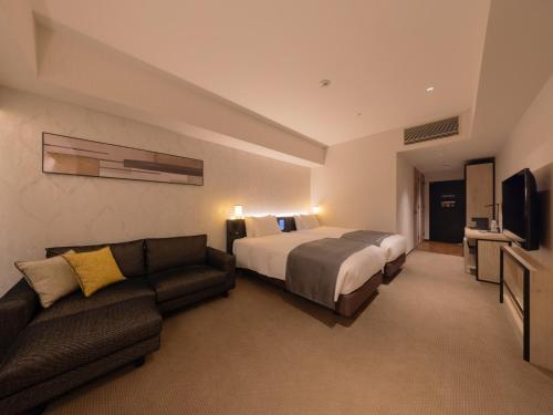 Postel nebo postele na pokoji v ubytování LIBER HOTEL Osaka
