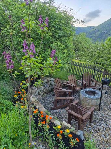 a garden with chairs and a fire pit and flowers at Бриндуш in Tatariv