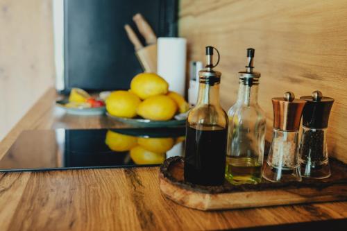two bottles of wine sitting on a wooden table at Baldones dabas retrīts - Exclusive private nature retreat with optional jacuzzi and sauna near Riga in Pulkarne