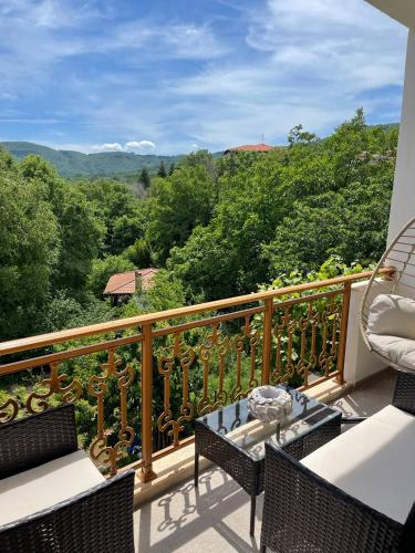 a balcony with chairs and a table and a view at Niki's Paradise View in Taxiarchis