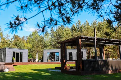 a house with a gazebo in a yard at Baldones dabas retrīts - Exclusive private nature retreat with optional jacuzzi and sauna near Riga in Pulkarne