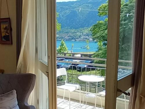 a room with a balcony with a view of a lake at Apartment Navigator's lodging in Kotor