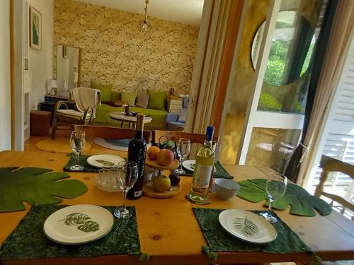 a wooden table with wine bottles and glasses on it at Apartment Navigator's lodging in Kotor