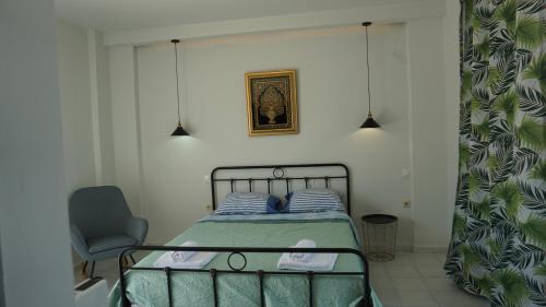 a bedroom with a bed and a chair in it at Sugarcubes by Evagstays in Faliraki