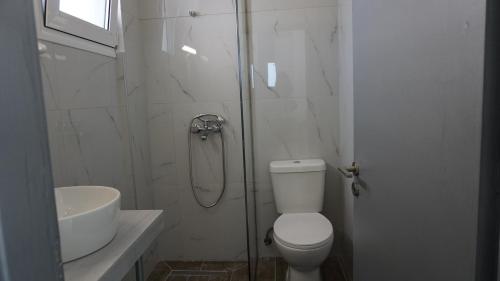a bathroom with a shower and a toilet and a sink at Sugarcubes by Evagstays in Faliraki