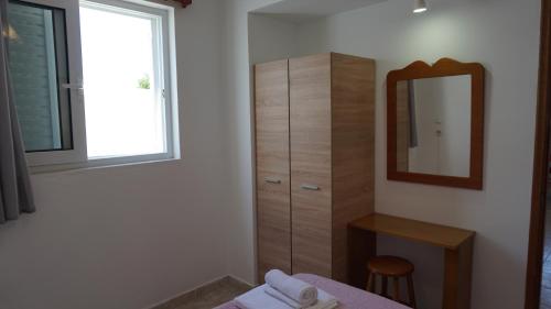 a bedroom with a dresser and a mirror and a bed at Sugarcubes by Evagstays in Faliraki