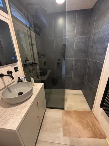 a bathroom with a sink and a shower at Stylish beach house in Privlaka in Privlaka
