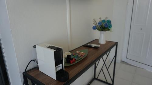 a table with a computer on top of it at Sugarcubes by Evagstays in Faliraki
