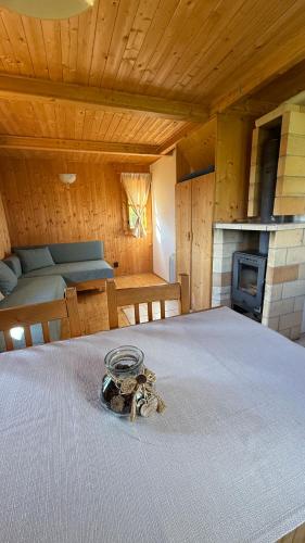 a room with a bed with a table and a fireplace at Bungalovy Baranec in Žiar