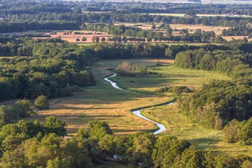 an aerial view of a river in a field at Ruim en rustig chalet in Nationaal park de Drentsche Aa max 5 prs in Anloo