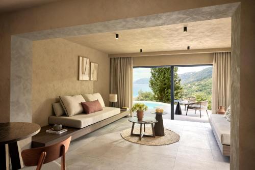 a living room with a couch and a table at Alkyna Lifestyle Beach Resort - Adults Only in Agios Gordios