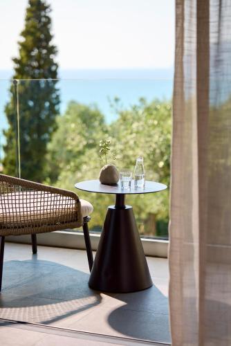a table in front of a window with a table with glasses on it at Alkyna Lifestyle Beach Resort - Adults Only in Agios Gordios