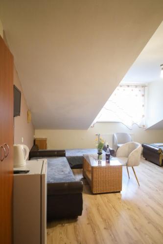 a living room with a couch and a table at Gospodarstwo Agroturystyczne Pod Lasem Maria Płazio in Narol