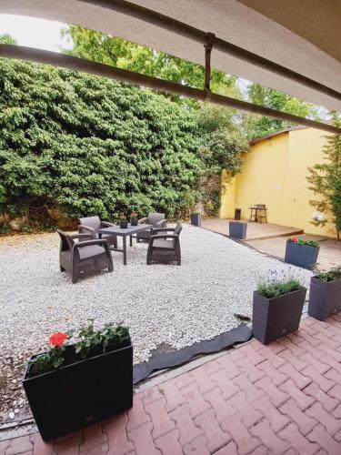 a patio with a table and chairs and plants at Willa Mira 200 metrów od morza in Międzyzdroje
