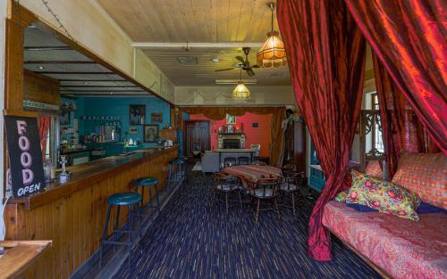 a living room with a couch and a bar at Robbie Burns Hotel Wyndham in Burragate