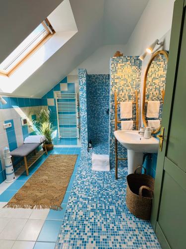 a bathroom with a sink and blue tiles at Carpathian Apartment and private parking in Odorheiu Secuiesc