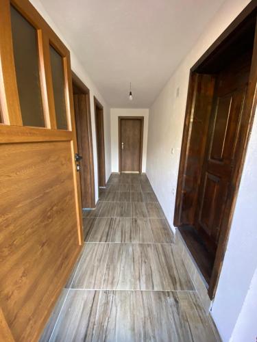 an empty hallway with wooden floors and a door at Chalet Jelovica in Berane
