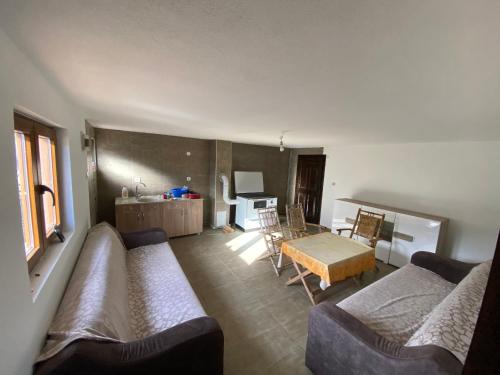a living room with a couch and a table at Chalet Jelovica in Berane