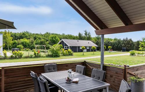 a table and chairs on a deck with a playground at Pet Friendly Home In Sydals With Sauna in Neder Lysabild