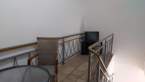 a balcony with a table and a television at Mon Ami Loft Apartment in Tsovazard