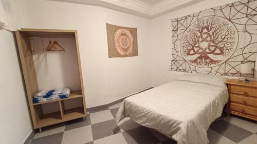 a bedroom with a bed and a dresser and a mirror at La BODEGA DE ROSARIO in Algodonales