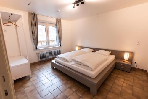 a bedroom with a bed and a window at Aan de bosrand in Oudsbergen 