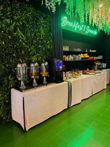 a buffet line with two tables with food on them at Hostel POINT in Nova Gorica