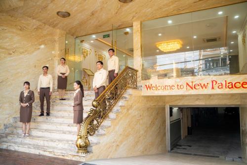 a group of people walking down stairs in a building at NEW PALACE HOTEL in Quang Ngai