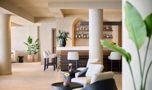 a living room with a couch and a bar at Alkyna Lifestyle Beach Resort - Adults Only in Agios Gordios