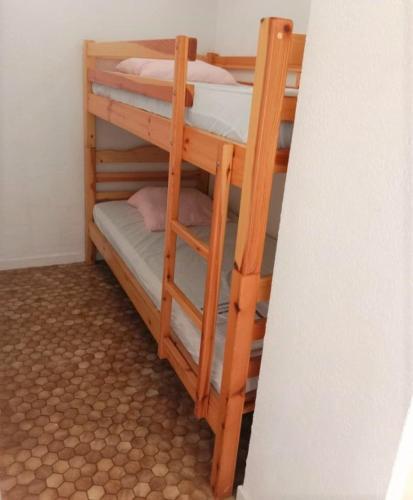 quelques lits superposés dans une chambre dans l'établissement AGREABLE STUDIO CABINE DONNANT SUR TERRASSE AVEC VUE MER, au Cap d'Agde