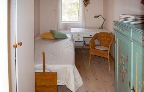 a bedroom with a bed and a desk and a chair at Nice Home In Åkersberga With Wifi in Åkersberga