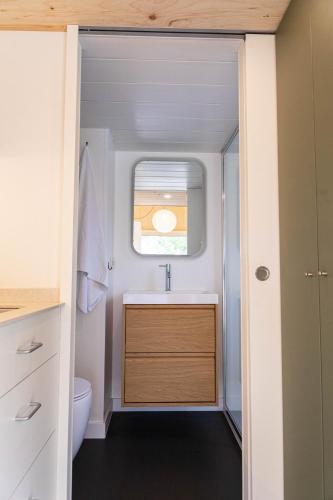 a bathroom with a sink and a window at HolaCamp Sitges Garrofer in Sitges