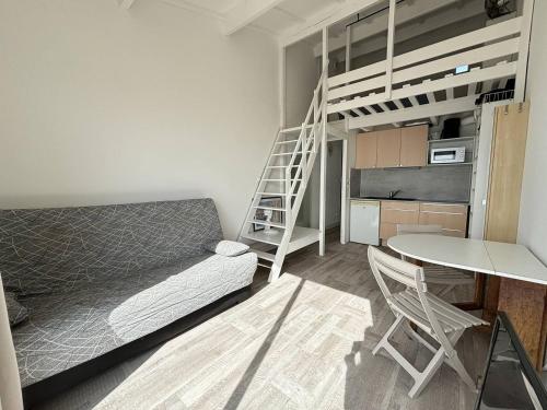 - une chambre avec des lits superposés, une table et une échelle dans l'établissement APPARTEMENT AVEC TRES BELLE VUE MER, au Cap d'Agde