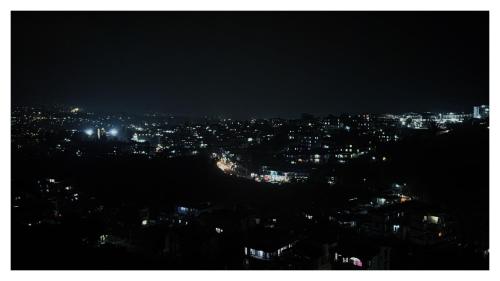 a view of a city at night with lights at Zion Backpackers Hostel Shillong in Shillong