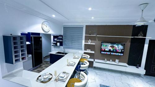 a large bathroom with a sink and a tv at Casa Viola Properties in Takoradi
