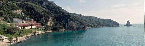 a body of water with a beach and a mountain at Alkyna Lifestyle Beach Resort - Adults Only in Agios Gordios