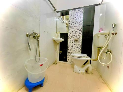 a bathroom with a toilet and a shower and a sink at COZY NEST Homestay & Rooftop Cafe in Agra
