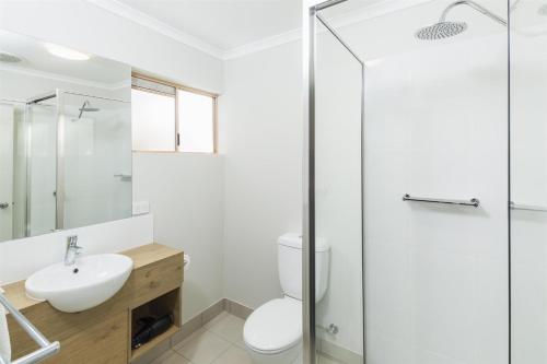 a bathroom with a white toilet and a sink at Nightcap At Balaclava Hotel in Cairns