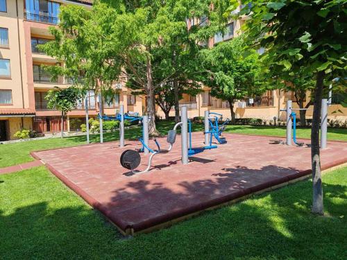 a playground with blue equipment in a park at Magic Dreams Apartments in Sveti Vlas