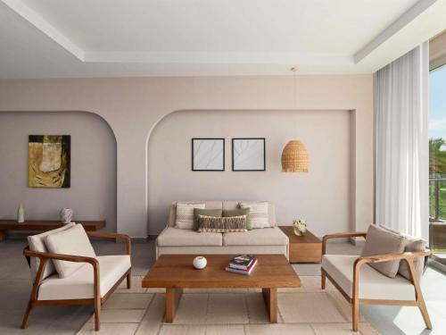 a living room with a couch and two chairs at Rixos The Palm Hotel & Suites - Ultra All Inclusive in Dubai