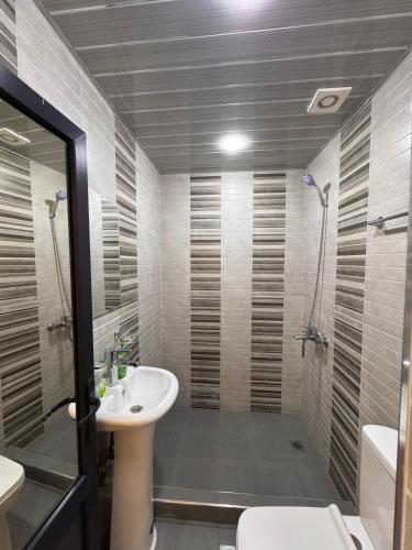 a bathroom with a sink and a shower at R Hotel Yerevan in Yerevan