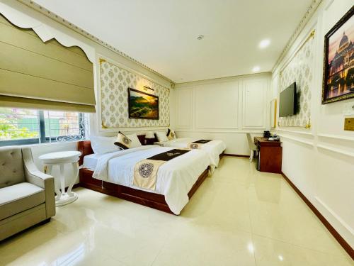 a bedroom with a large bed and a chair in it at NEW PALACE HOTEL in Quang Ngai