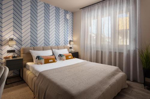 a bedroom with a large bed and a window at Villa Veg in Umag