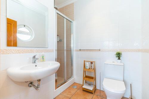 a bathroom with a sink and a toilet and a shower at Villa Serena-gorgeous Rural Family Villa & Pool in Morenos