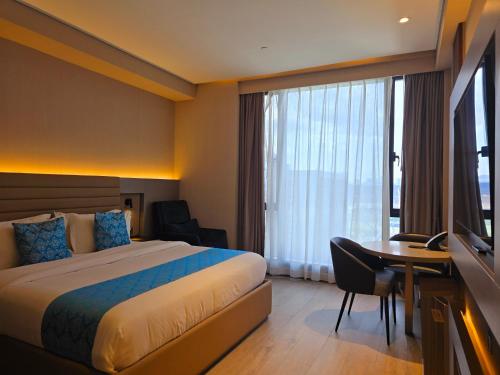 Postel nebo postele na pokoji v ubytování Bayprime Hotel