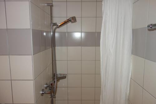 a shower with a shower head and a shower curtain at Pracondu 2 406 - OUTDOOR & FUN apartment 6 pers in Nendaz