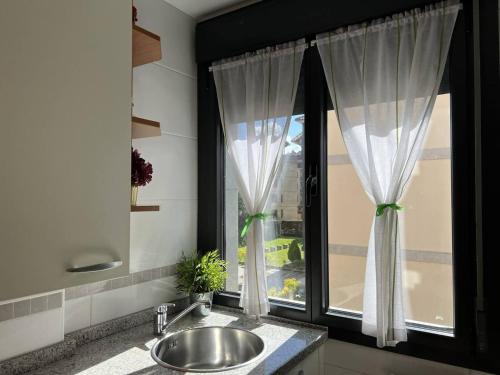 a bathroom with a sink and a window at El Mirador del Orfanato 1C in Llanes